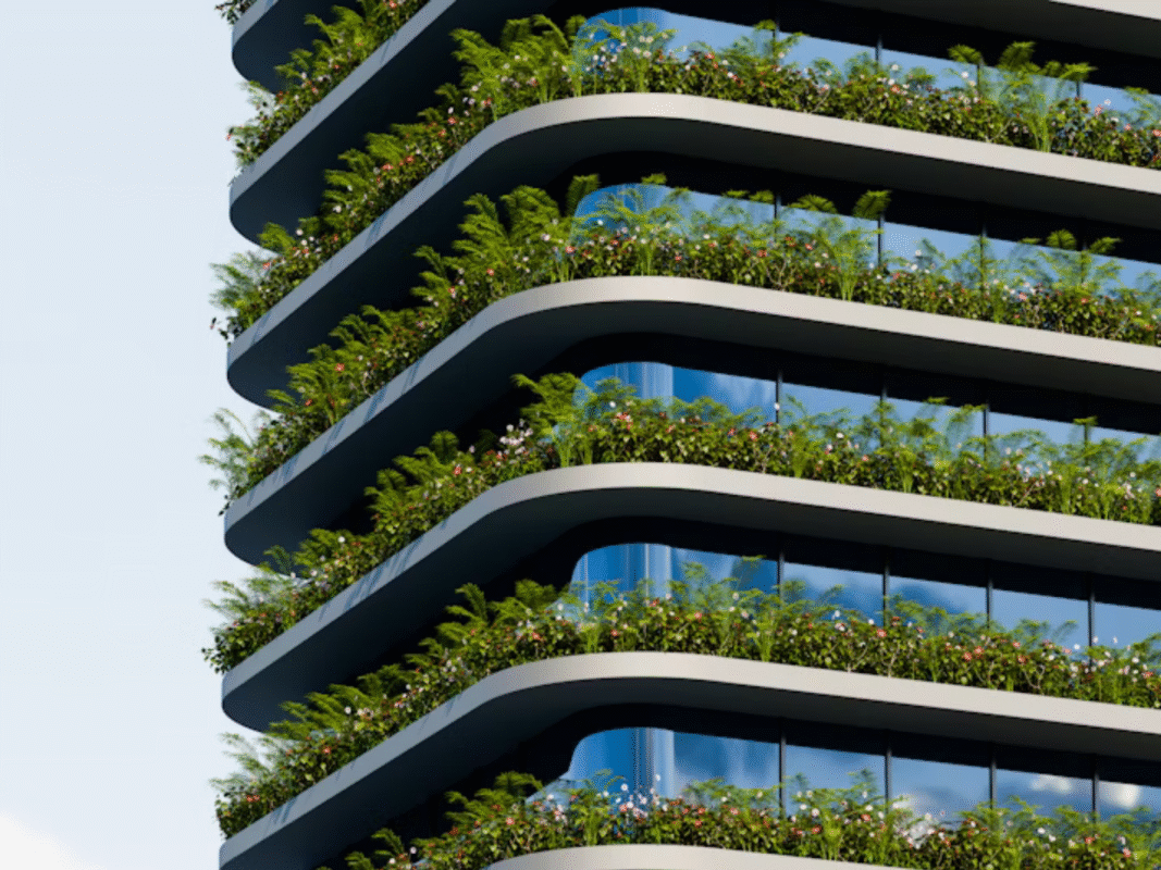 Eco-friendly building with glass façade and greenery on each balcony level