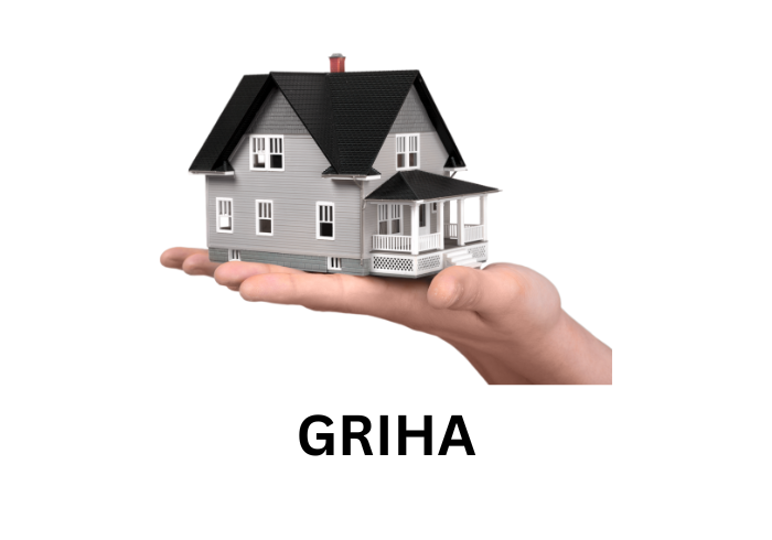 Hand holding a miniature house symbolizing GRIHA green building certification. Infranox Global Solutions.