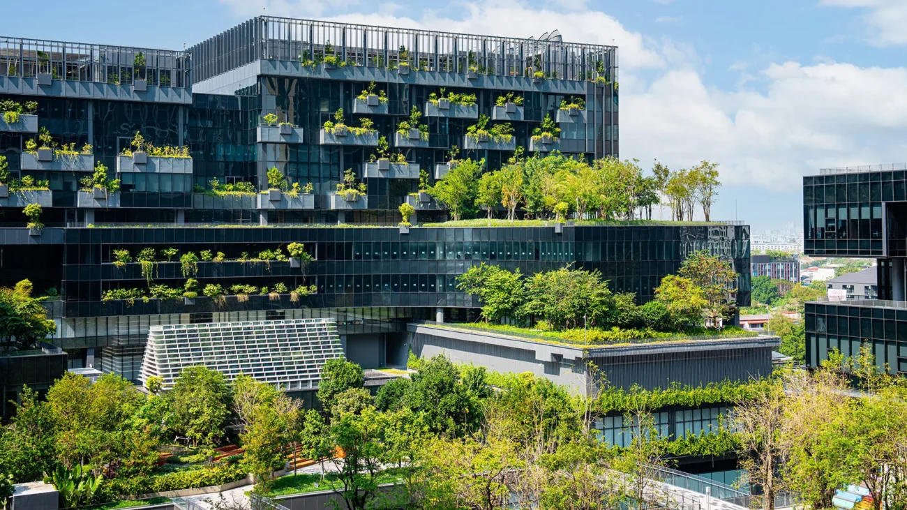 Green building with multiple buildings surrounding image